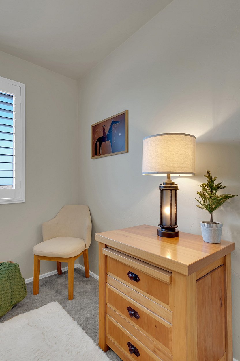 Unpack and settle in with a spacious wood dresser, lantern-style lamp, and a cozy accent chair by the window.