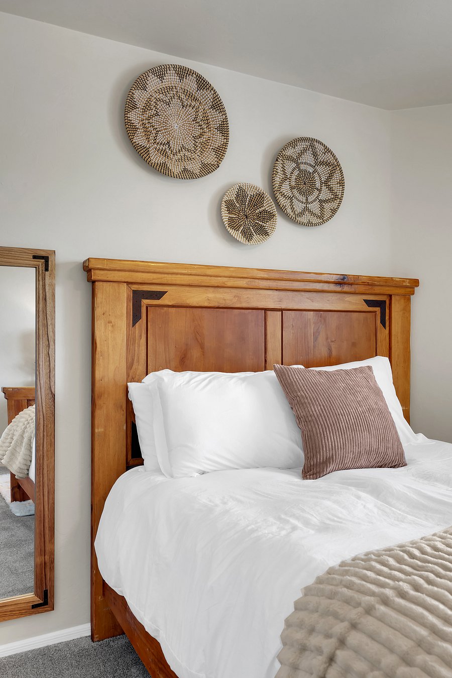 Rustic wood craftsmanship meets crisp white linens and cozy textures for a comfy, elevated night's sleep.