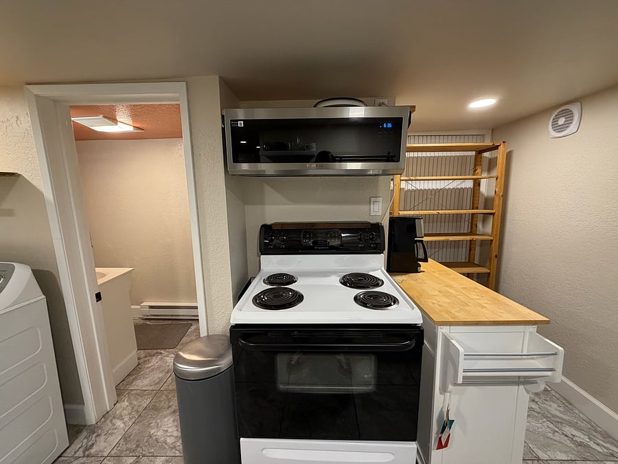 Oven range with microwave and shelving for pantry items