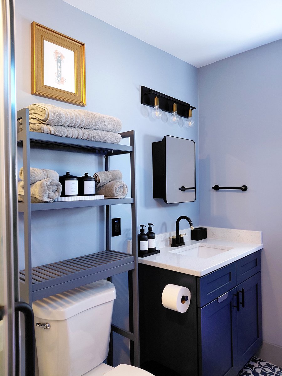 Bathroom Essentials - Refresh & wind down in this thoughtfully appointed bathroom, featuring a rich navy vanity, modern fixtures, plush towels, and carefully curated amenities. Stylish touches and cozy comforts are curated to make you feel right at home.