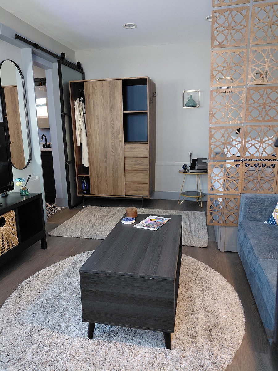 Sleep Zone - A versatile twin-size trundle bed with integrated storage drawers easily converts to a queen-size bed. A handsome walnut wardrobe provides ample hanging & folded storage; full size mirror, charging station & bedside lamps finish the area.