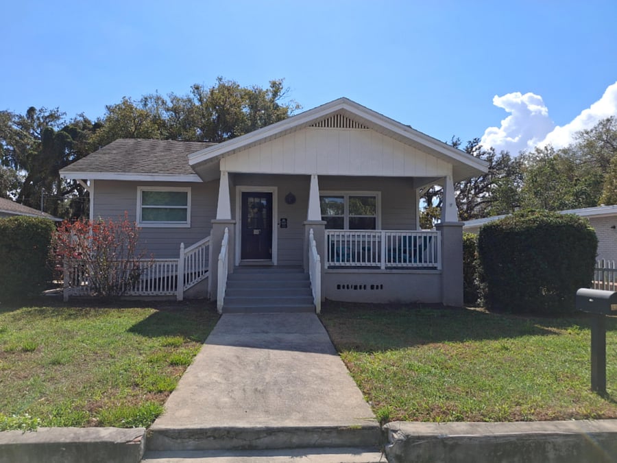 Front of Host Home - Florida bungalow with welcoming front porch in the charming, historic Seminole Heights neighborhood, a diverse area merging suburban serenity & lively city culture, with Host Nadine providing the utmost in hospitality.