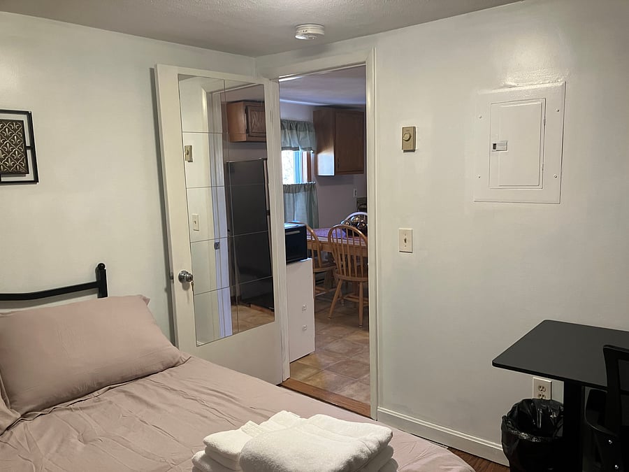 3rd floor full size bedroom looking into kitchen view