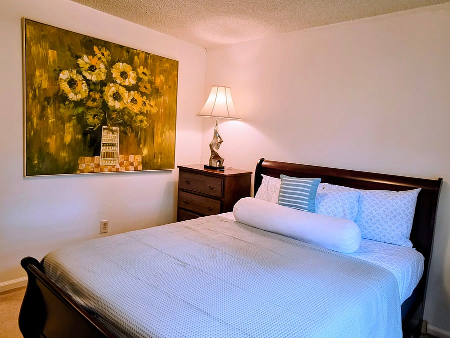 Furnished queen bedroom with comfortable bedding