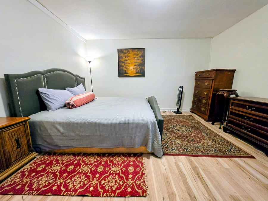 Comfortable master bedroom with king sized bed, ample storage, and a walk-in closet
