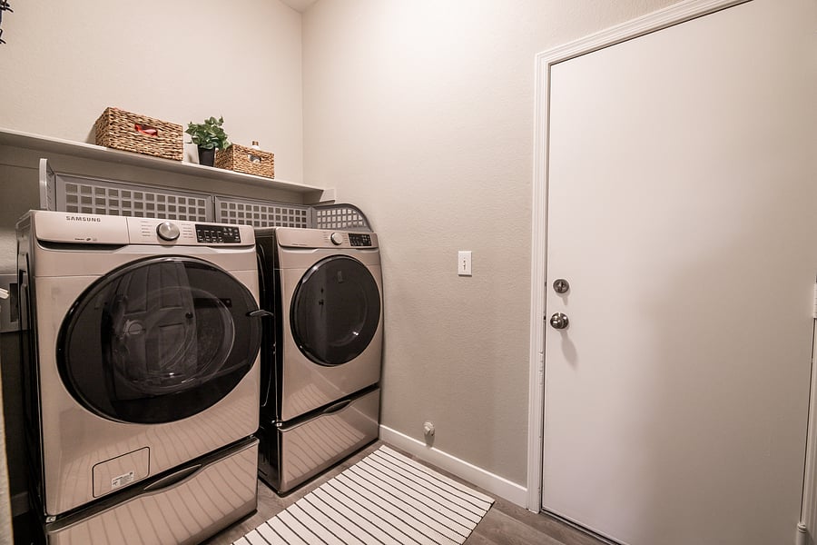 washer and dryer on main by garage entrance