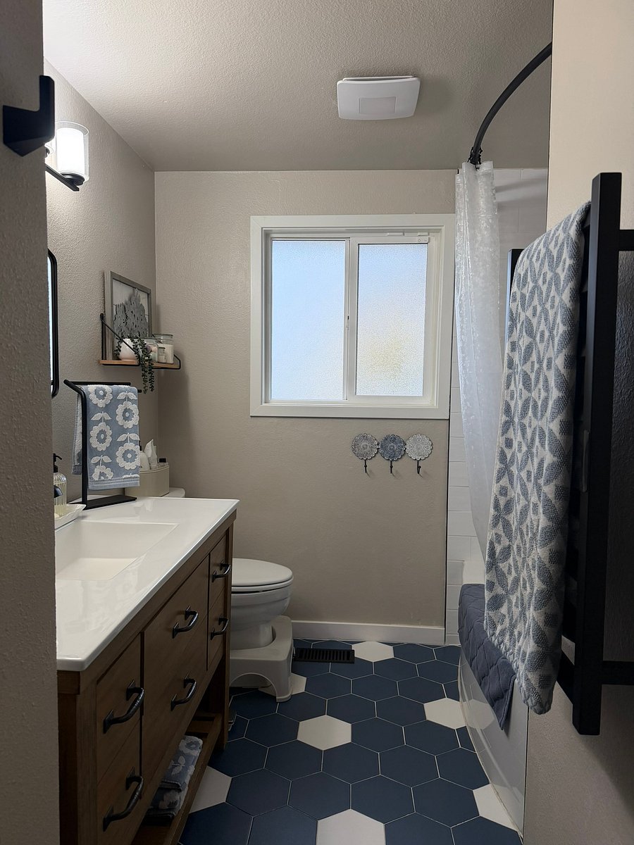Completely updated bath with tub/shower combo, heated towel rack, bidet toilet, and plenty of shelving for storage.
