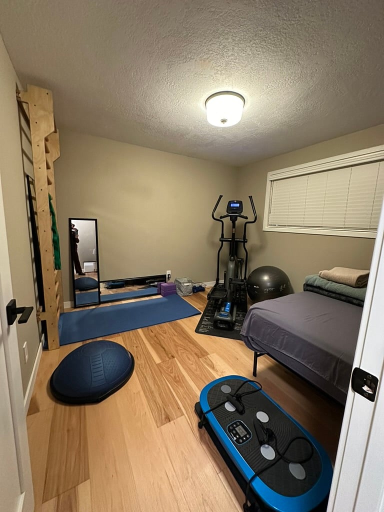 Second bedroom has Murphy bed that folds up into the closet. Subsequent to this photo, a wall-mounted TV and a freestanding clothing rack w/shelves have been added.
