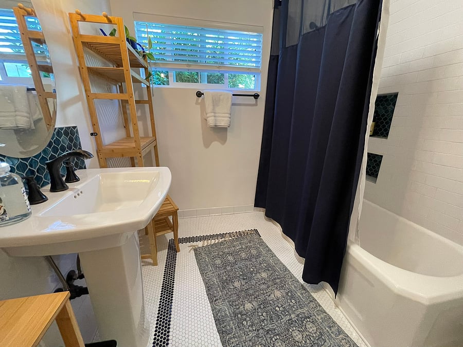 Deep tub, cute niches, storage that doubles as a vanity. Add your robes for at at home soaking and primping.