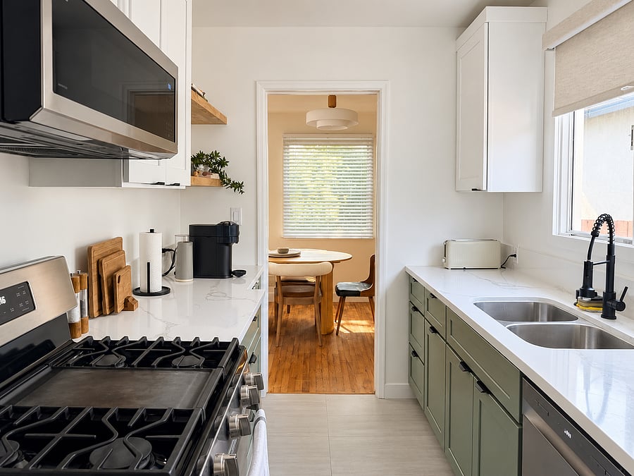 Fully remodeled kitchen with stainless steel appliances, generous counter space, double-basin sink, and easy access to the separate dining room.