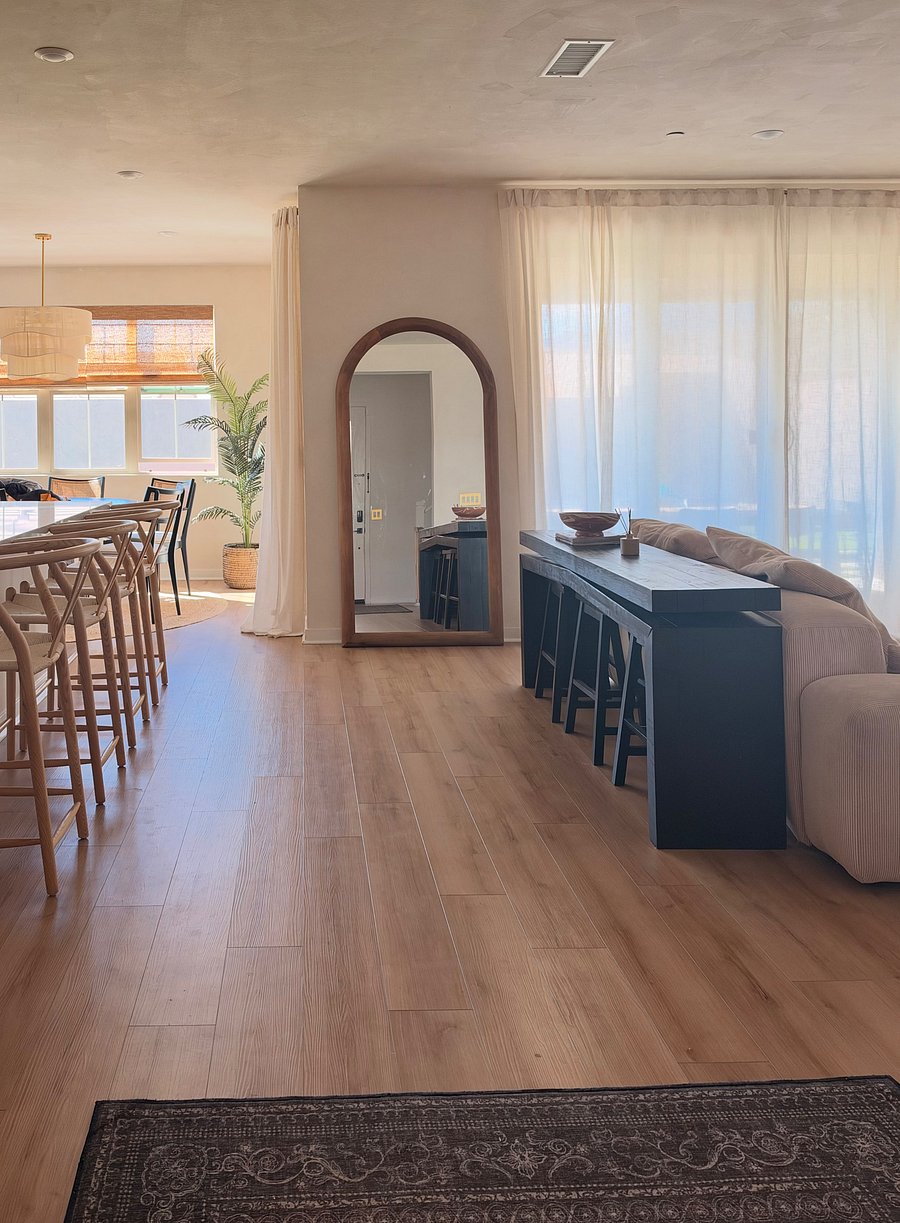 Large kitchen island, dining with natural lighting, open concept living with indoor outdoor seating, frame tv, imported lime washed walls