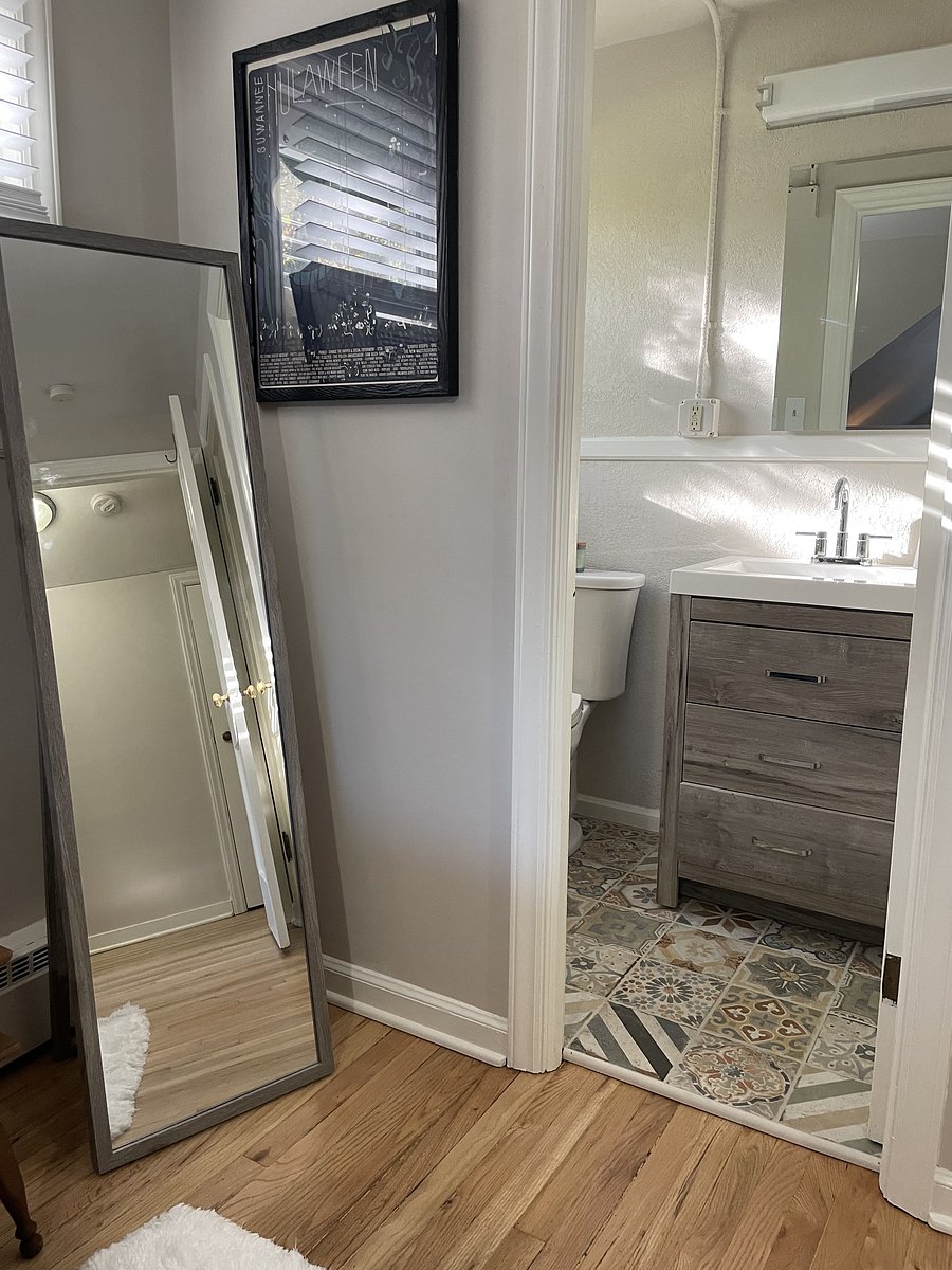 What a long, strange trip it would be without a bathroom upstairs! This charming half bath features a stylish vanity, unique patterned tile flooring, and everything you need for a quick refresh. Convenient connected to the upstairs bedroom.