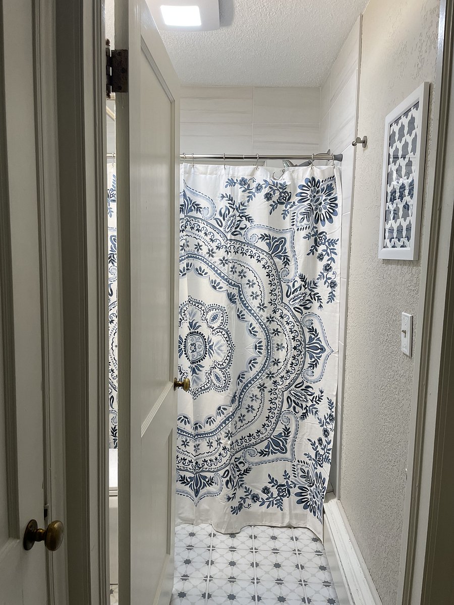 The newly remodeled full bathroom is found on the main level with a walk in shower, stocked with bath products, and a magnetic shower wand.
