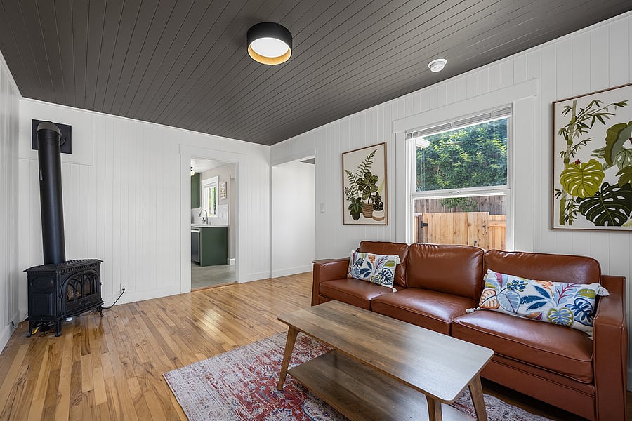 Living area has hardwood floors, gas fireplace and wall-mounted Smart TV. Great spot for working or relaxing.