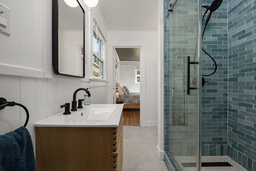 Newly remodeled bathroom with standing shower, ultra quiet exhaust fan, ample lighting, designer subway tile, modern fixtures + storage available in medicine cabinet and vanity. Nice light from south facing window. Triple weave fence lattice for privacy.