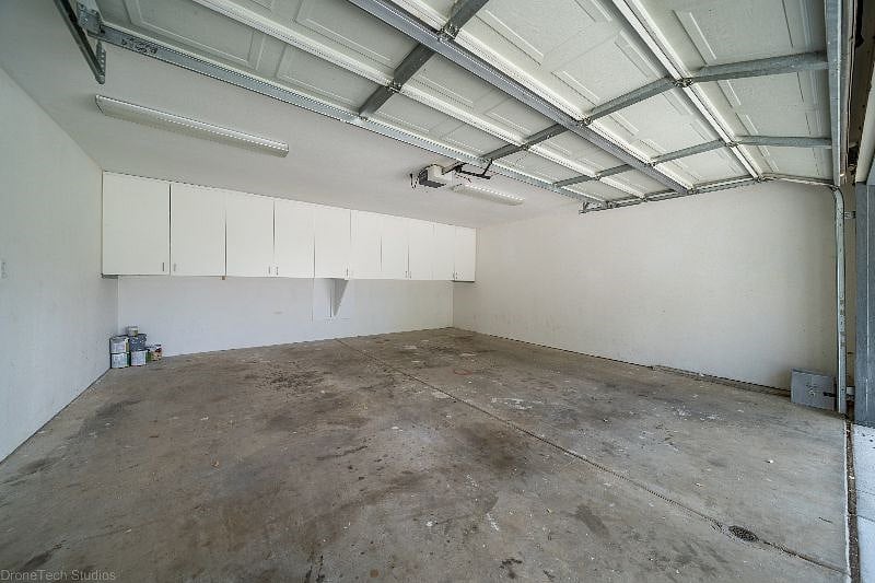 Two car enclosed garage with storage cabinets