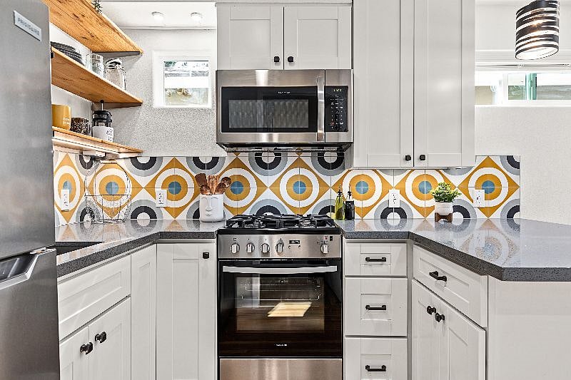 Full kitchen with stainless steel appliances and open shelving
