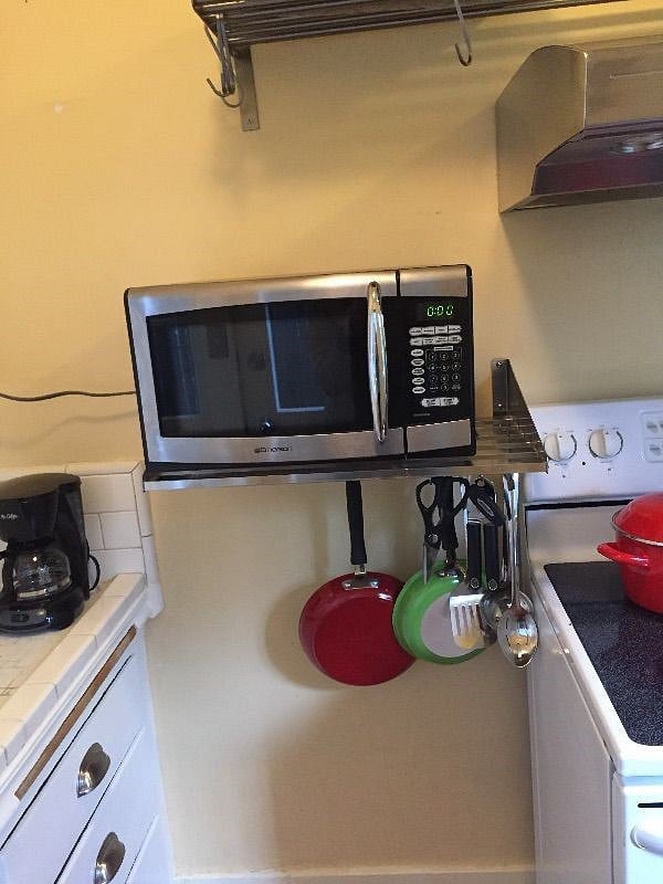 Kitchen: stove, refrigerator, microwave, kitchenware