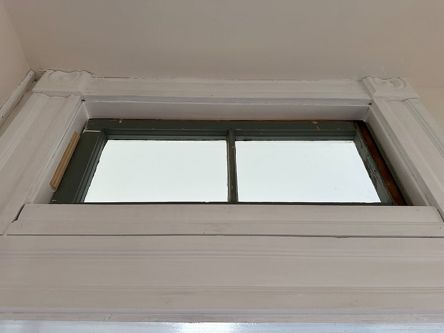 Bathroom transom window gives natural light to the entrance foyer.