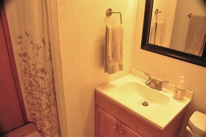 Bathroom sink to shower on left.