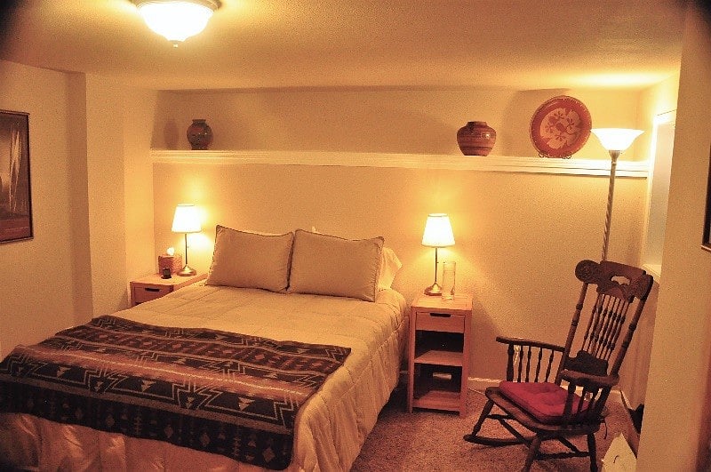 Queen bed in large, two closet bedroom. Boxes seen were tenants at the time of photographing; room is empty of others' possessions when you move in.

