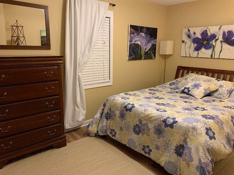 Lovely queen bedroom with ceiling fan.