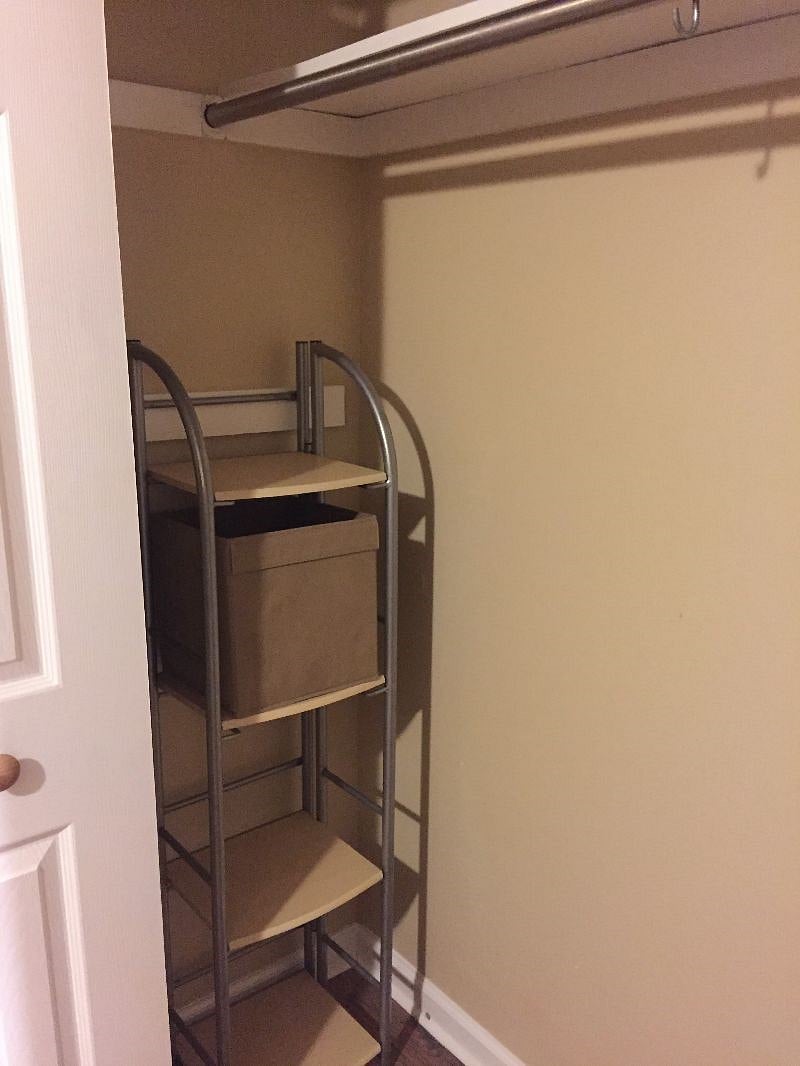 Double door closet with additional storage shelf.
