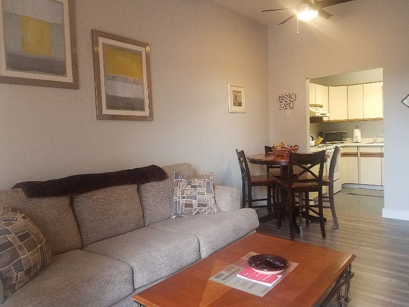 livingroom showing couch and dining area and full stocked kitchen