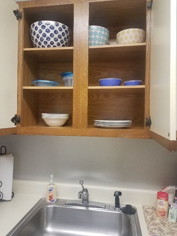 Kitchen cabinets fully stocked with dishes