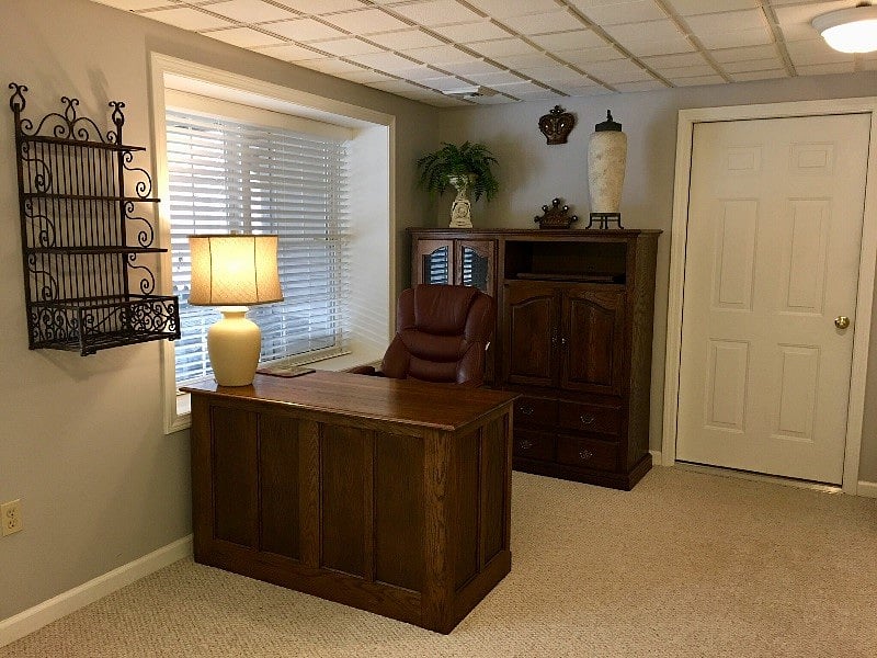 Desk, chair, and cabinet create a work space.