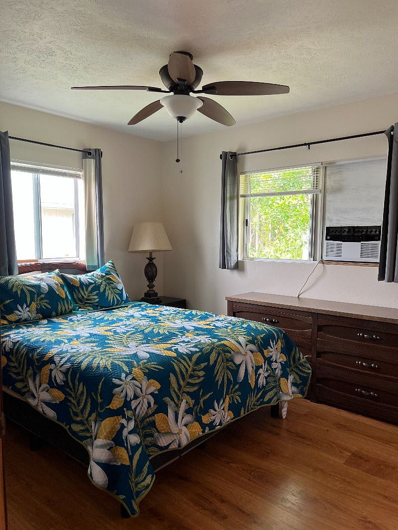 Master bedroom with half bath, large closet, large dresser, night stands with two lamps. MBR has air conditioner with remote control along with ceiling fan/light. Just installed new room darkening blinds and blackout drapes.