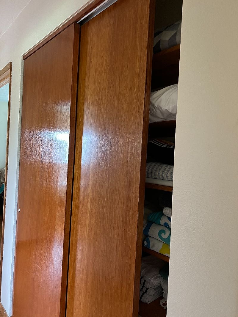 Large linen closet in hallway with new sheets, towels, blankets and comforters.