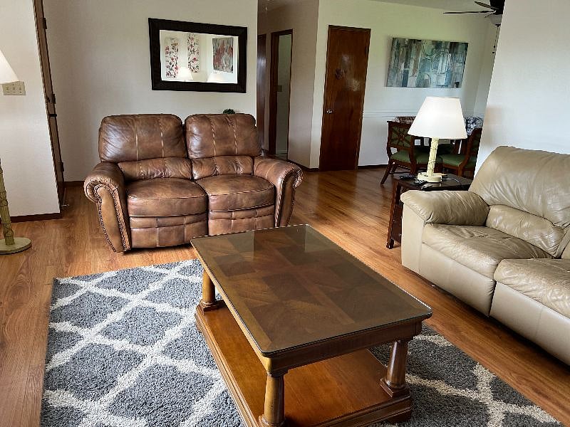Living room with new leather loveseat with recliners on each end.