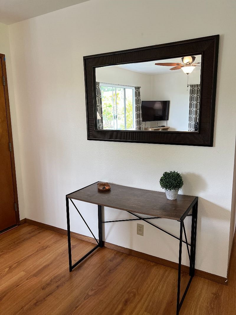 Front door entry area with table and mirror.
