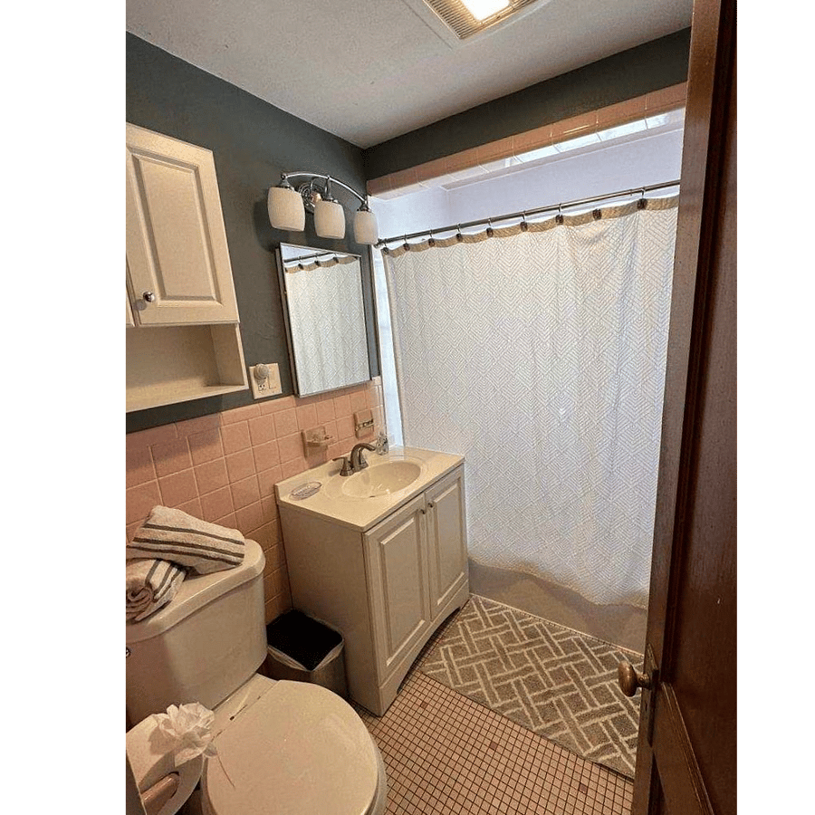 bathroom. in hallway between both bedrooms