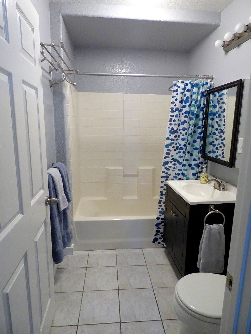 Bathroom showing tub & shower; curtain open