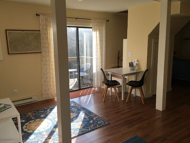 View from the kitchenette, small work or dinning table. Stairs to the upstairs unit, locked tight on both sides (no access). Nice little back deck seating as well outside the sliding glass.