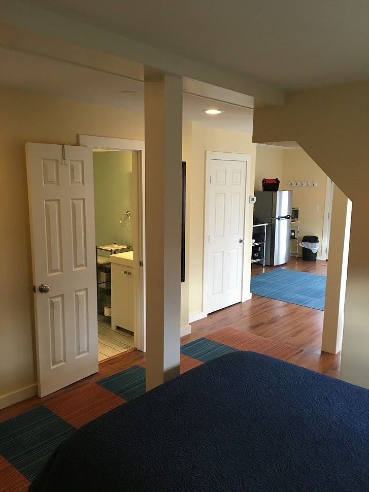 View for the bed area, bathroom to the left. That second door is a large storage closet.