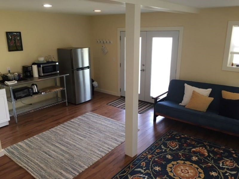 View of sitting area, kitchenette, and main entrance (at the base of the drive) There is also a concreate patio that wraps around to the back deck.