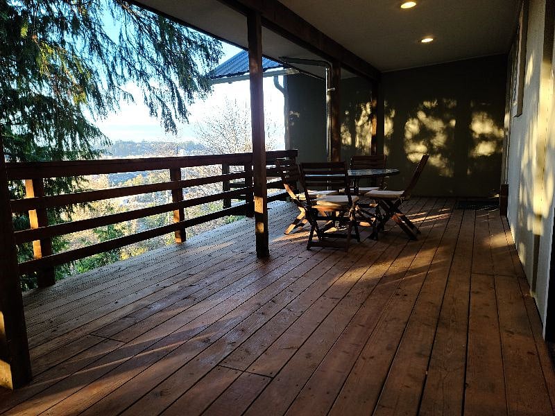 The deck wraps around the dining room and connects to a grass area.
For dogs comfort the screen door in the dining room is a soft screen, that dogs can open on their own and  access the yard to do their business. 