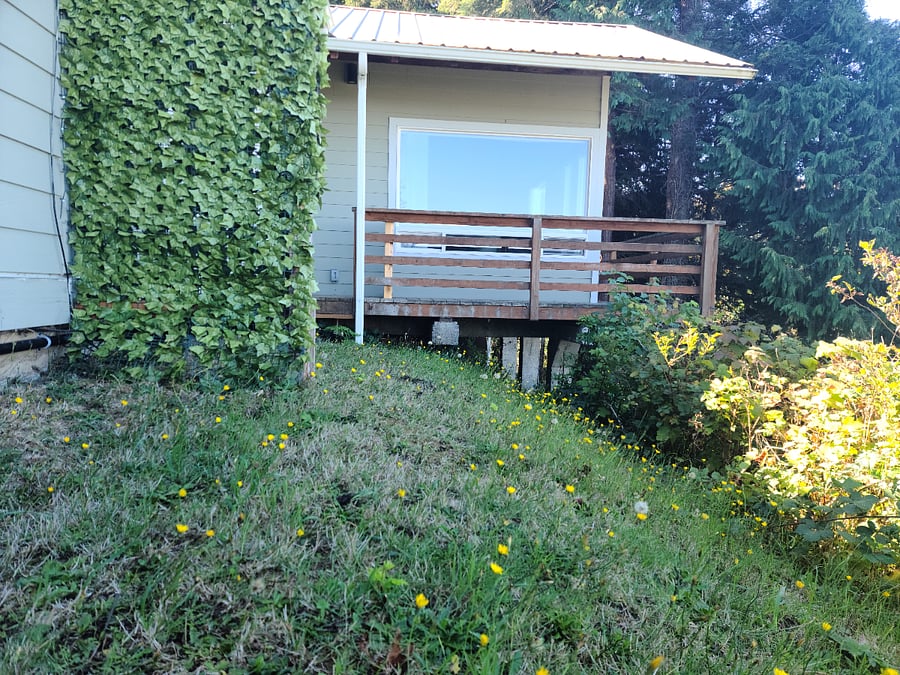 This grassy area connects to the large deck, the laundry room has a door that also connects to the deck. 