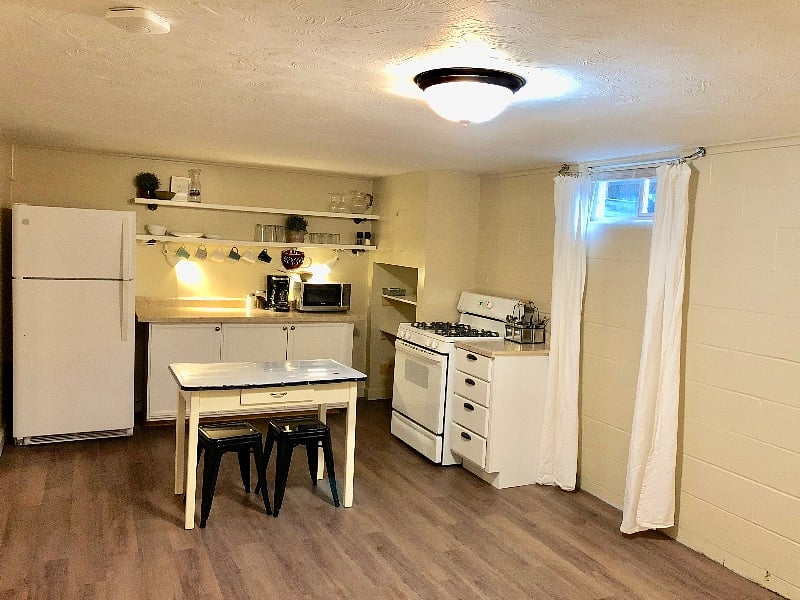 The fully stocked kitchen includes a full-sized refrigerator, stove, microwave, coffee maker, etc.