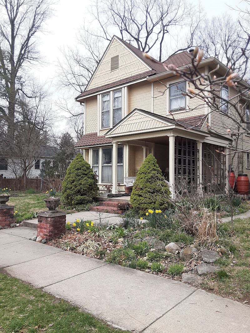 This photo shows a springtime scene, but there is always a multitude of flowers in the summer - on porch and in the yard.