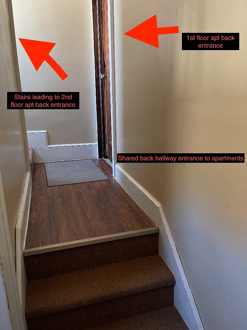Shared back hallway leading to entrances to both apartments.