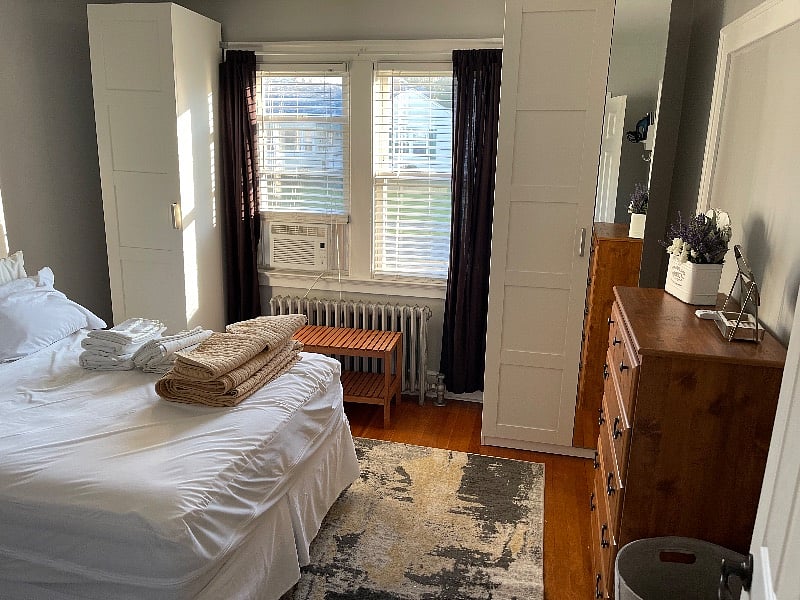 Second bedroom with full size bed and two closet storage units along with dresser drawer. 