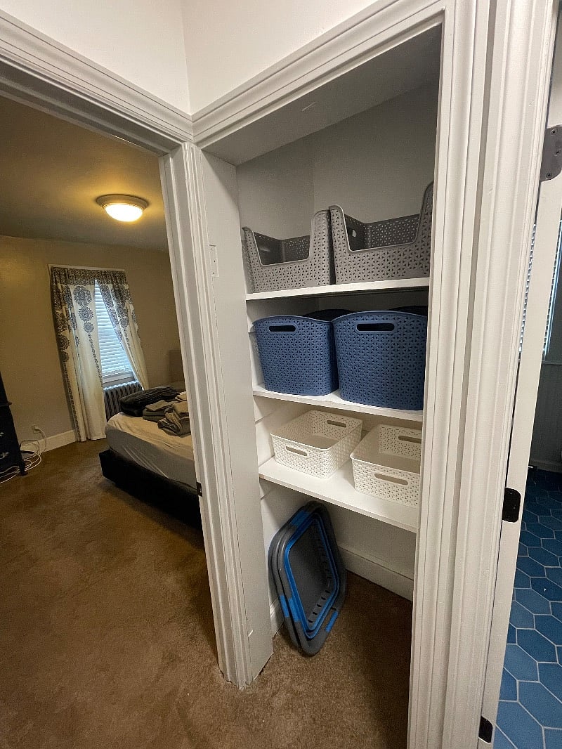 Storage closet in hallway between bathroom and master bedroom. Storage bins available for use, as well as a collapsible laundry basket. 
