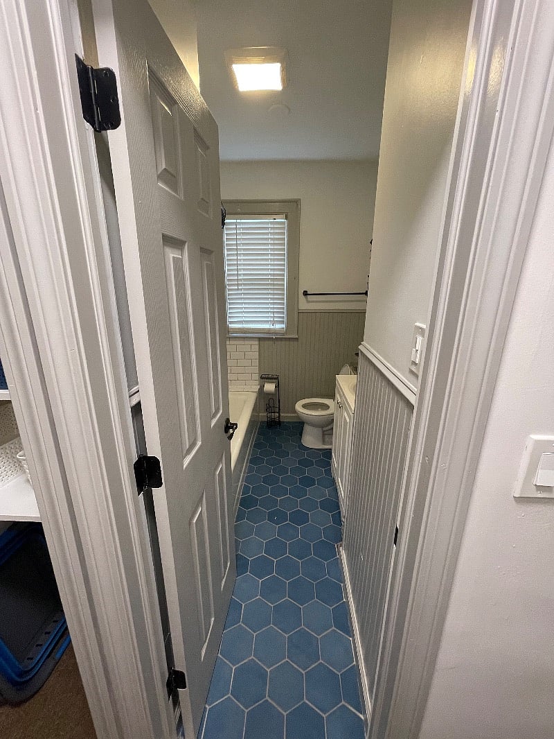 Newly renovated bathroom with shelving, large mirror, air vent and great lighting. 