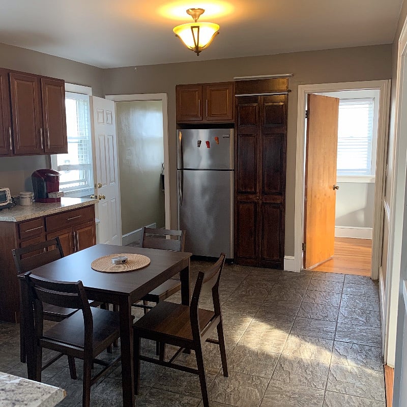 Kitchen with full size refrigerator and pantry.