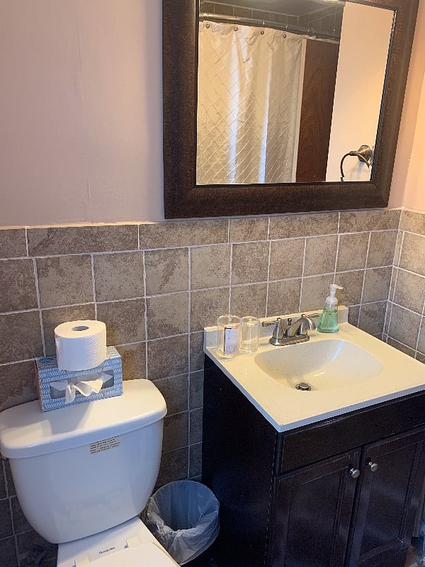 Bathroom vanity with large mirror.