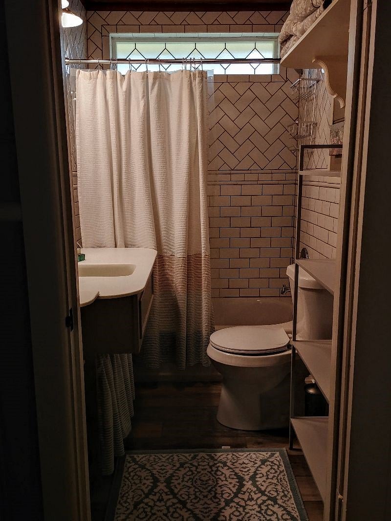Bath is between bedroom and living area.